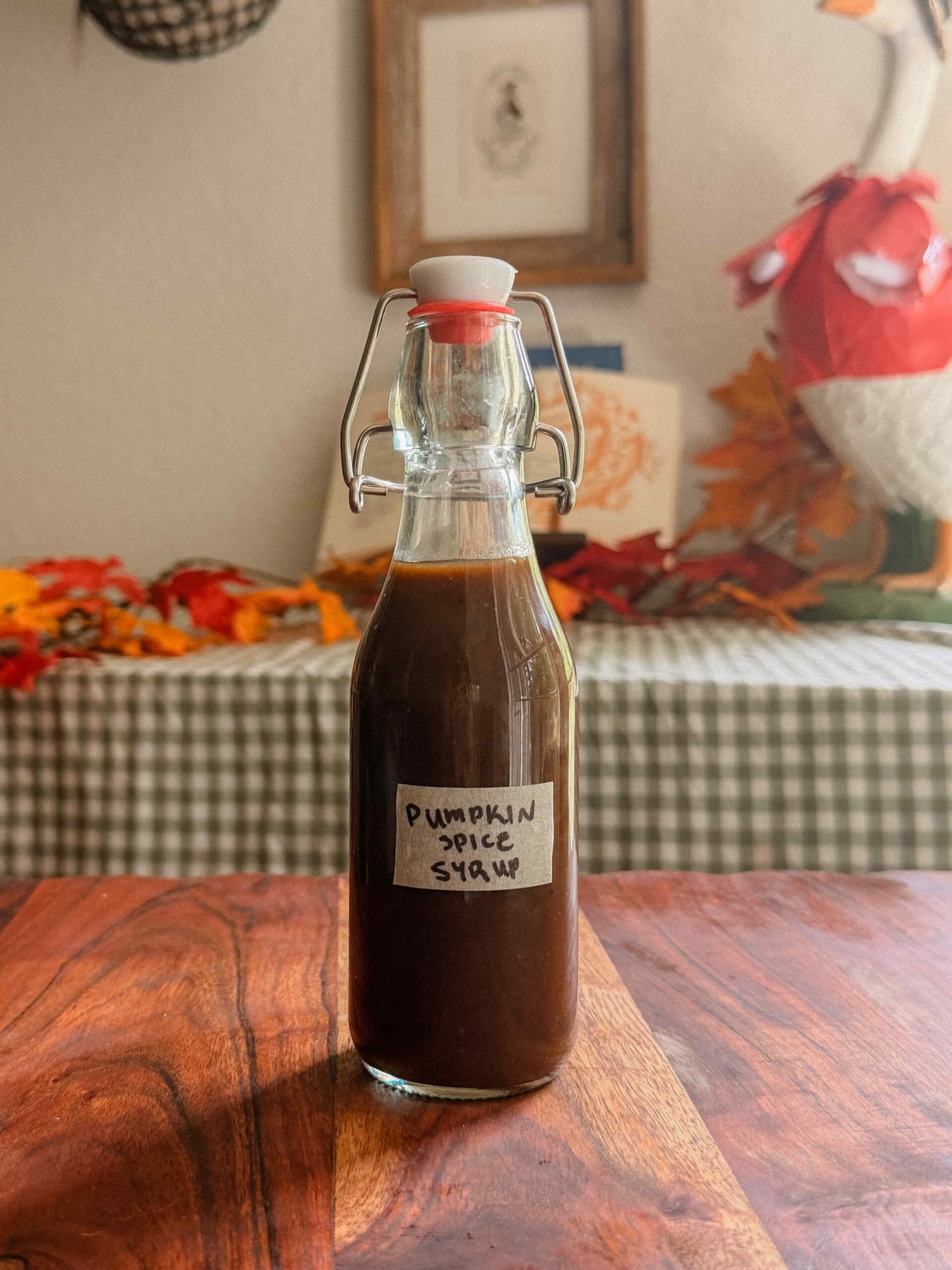 Homemade pumpkin spice syrup in a glass bottle